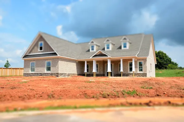 A new house with a sprinkler system ready for a waterwise landscape